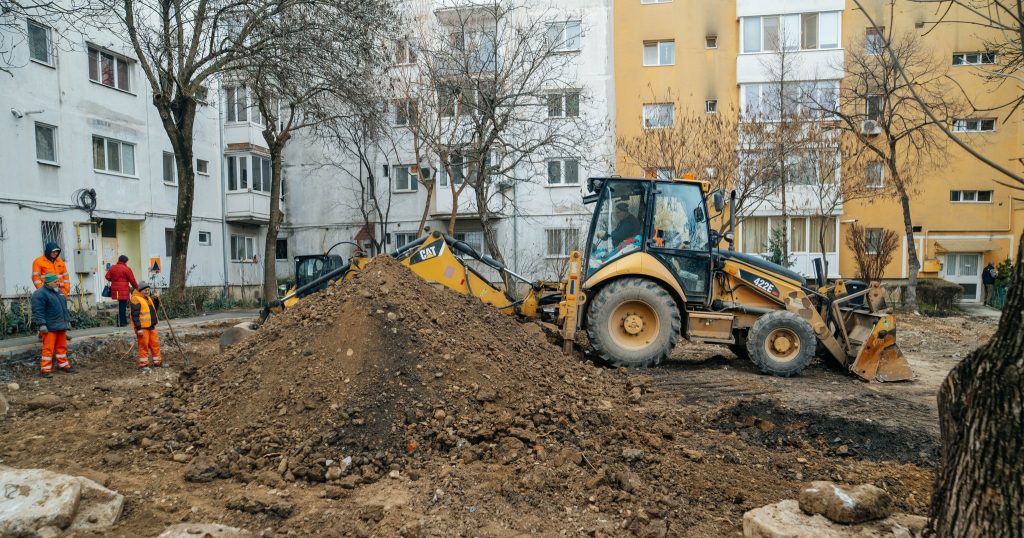 Utilaje și echipe de lucru care asfaltează noi locuri de parcare în cartierele Lipovei și Dâmbovița, pe locul fostelor garaje.