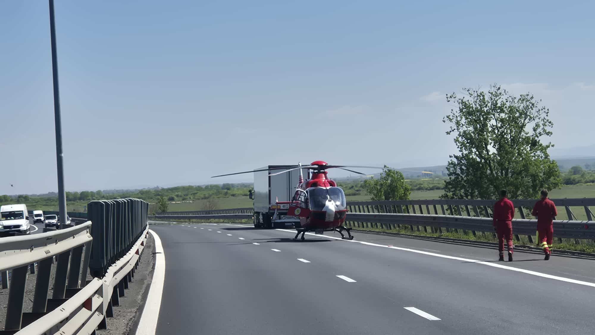 Elicopter SMURD aterizat pe autostrada A1 pentru preluarea victimelor unui accident între un microbuz și un TIR.
