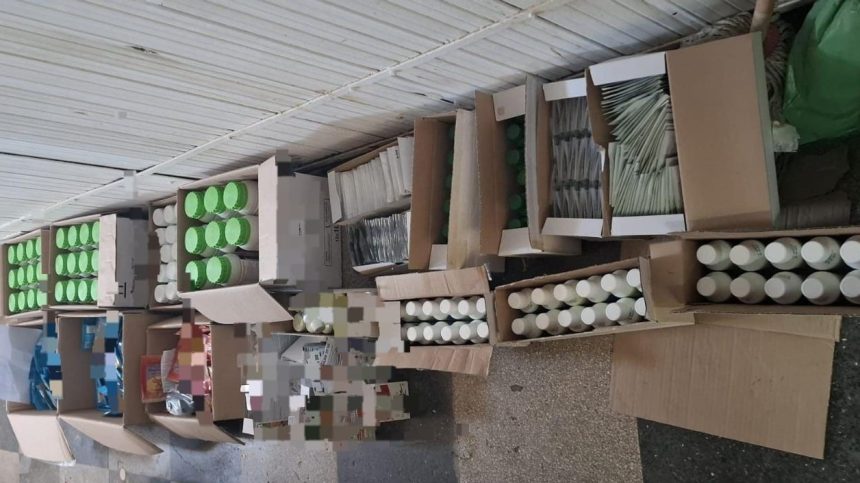 Polițiști din cadrul IPJ Hunedoara verificând și sigilând bidoane cu substanțe chimice și deșeuri periculoase într-un magazin.
