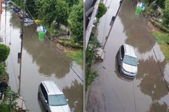Străzi inundate în municipiul Lugoj cu mașini care înaintează cu dificultate prin acumulările mari de apă de pe carosabil.