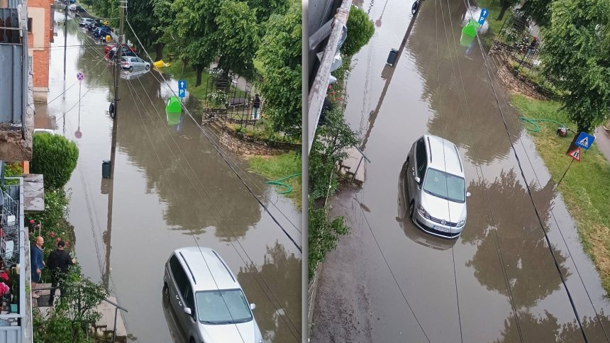 Străzi inundate în municipiul Lugoj cu mașini care înaintează cu dificultate prin acumulările mari de apă de pe carosabil.
