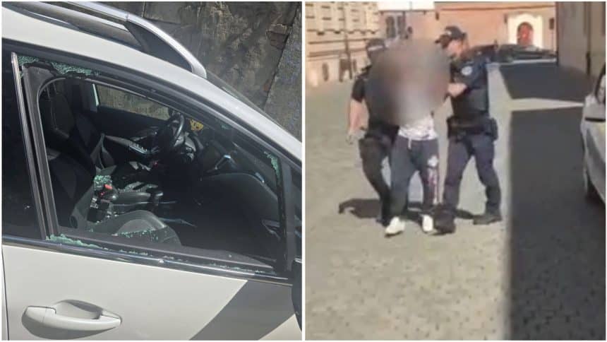 Geam lateral al unei mașini parcate spart cu o piatră în urma unui jaf de camere de bord pe o stradă din Timișoara.