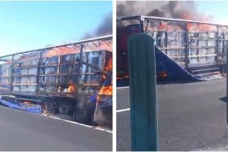 Semiremorcă de autotren cuprinsă de flăcări violente și coloană de fum negru pe banda de urgență a autostrăzii A1.