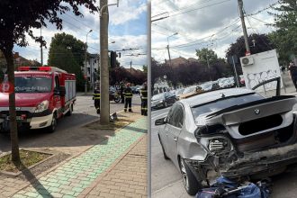 Două autoturisme marca BMW avariate pe strada Cluj din Timișoara, în urma unei coliziuni provocate de neacordarea de prioritate la virajul la stânga.