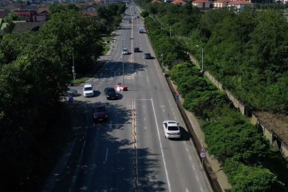 Utilaje de asfaltare și muncitori pe șantierul noului sens giratoriu de pe drumul județean care leagă Timișoara de comuna Giroc.